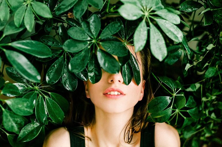 woman-in-black-top-beside-green-leafed-plant-1078058